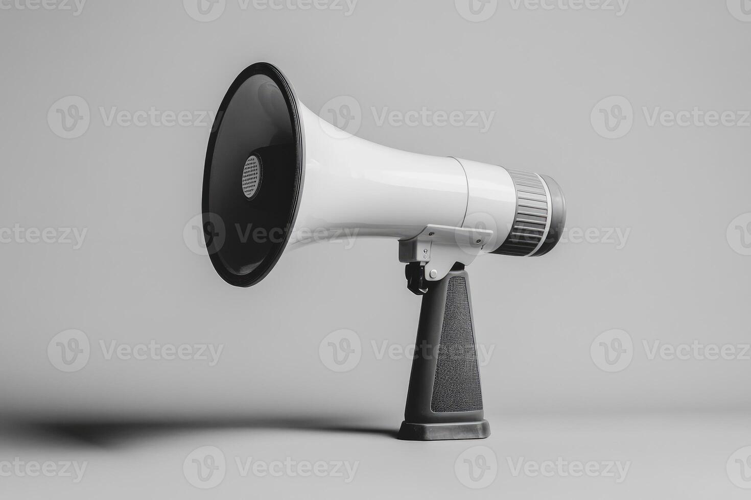 White Megaphone with Black Handle and Speaker on Gray Background photo