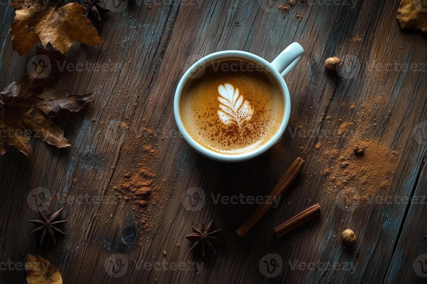 A Cup of Latte with Cinnamon and Autumn Accents on a Rustic Wooden Table photo