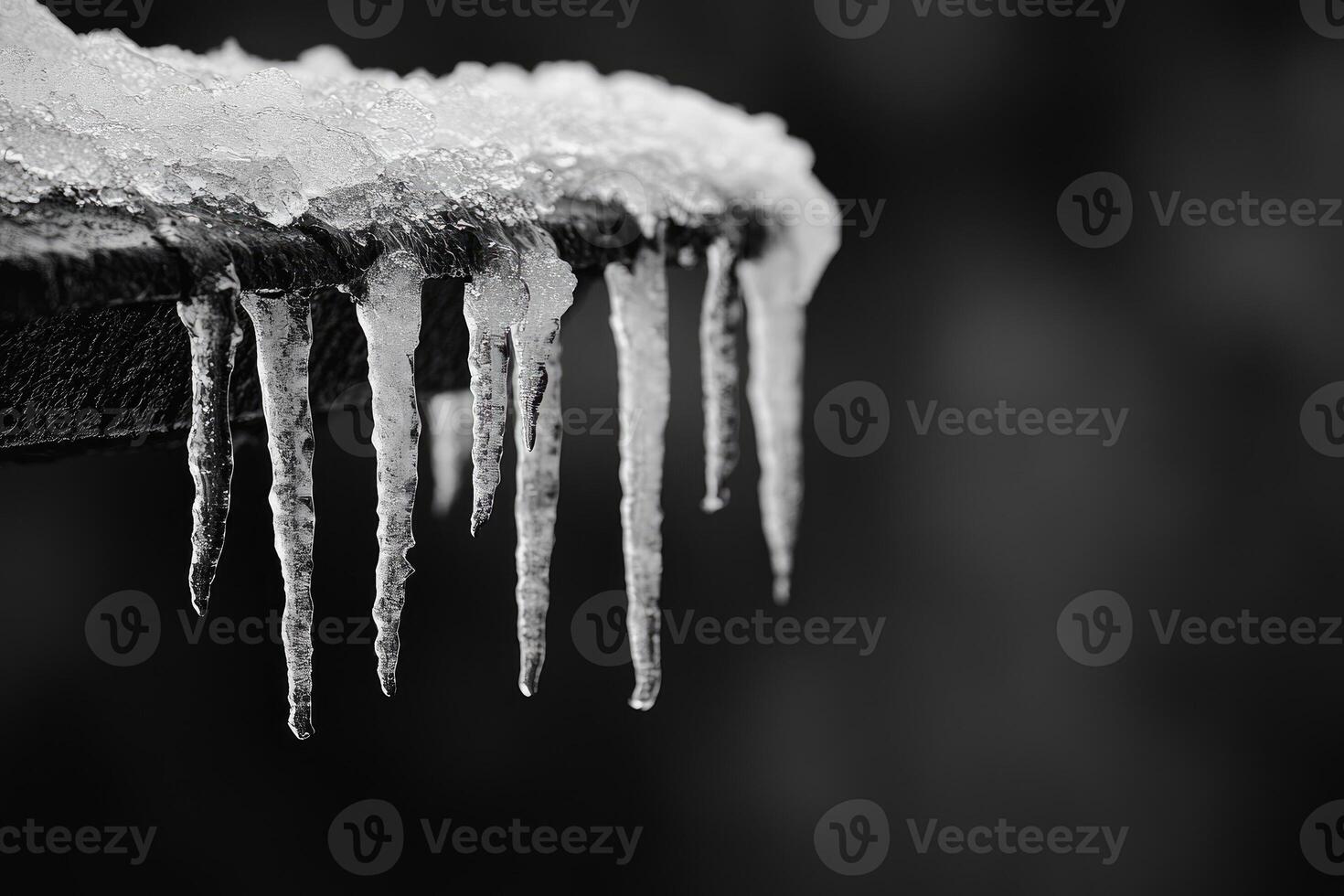 Icicles Hanging From a Surface in Black and White photo
