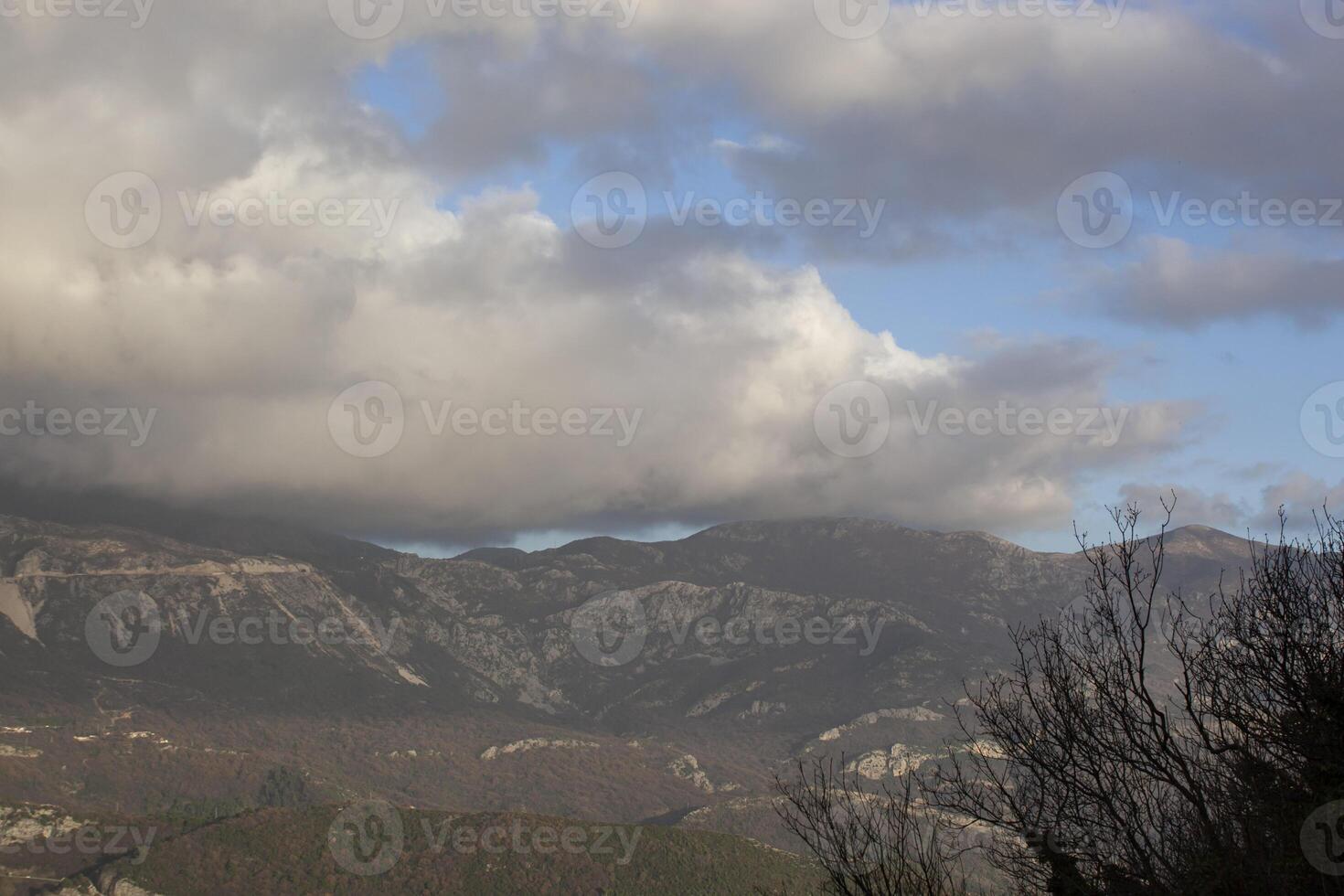 Winter in the mountains, beautiful mountain landscape. View of a mountain ridge and bare trees. Landscape in haze and cliffs. Budva, Montenegro. Europe. Background. For text. Banner. Postcard. photo