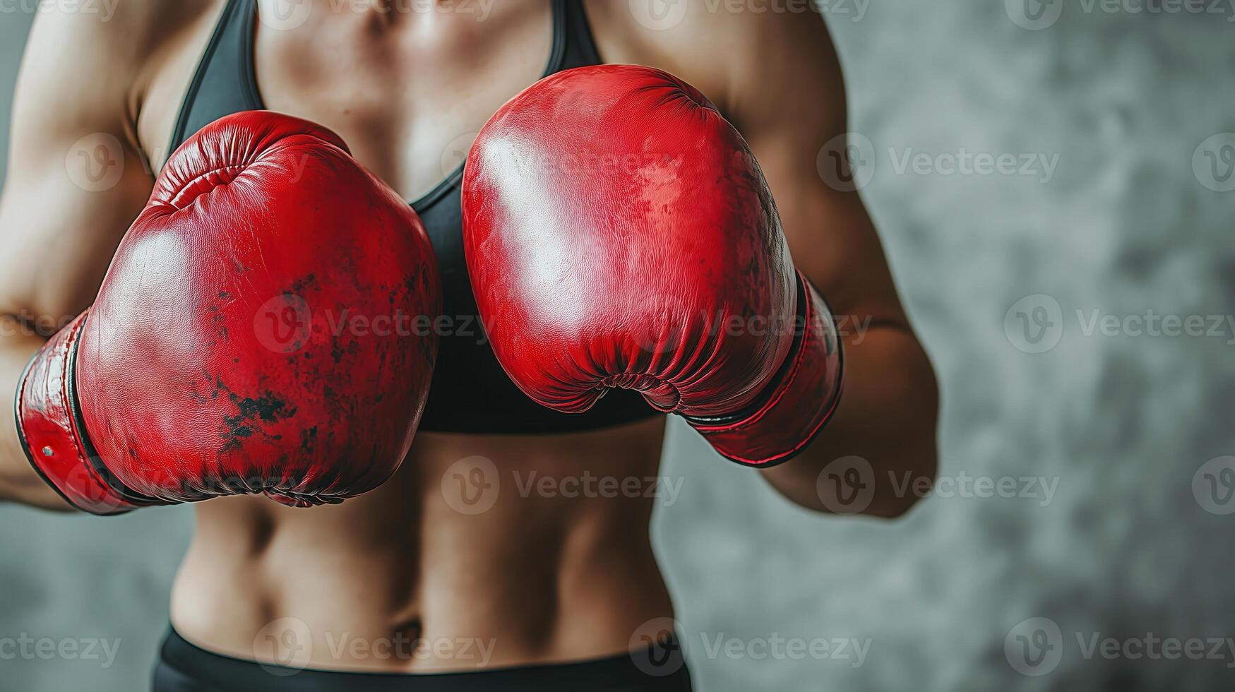 Closeup of athlete wearing red boxing gloves in fighting stance, showing strength and determination photo