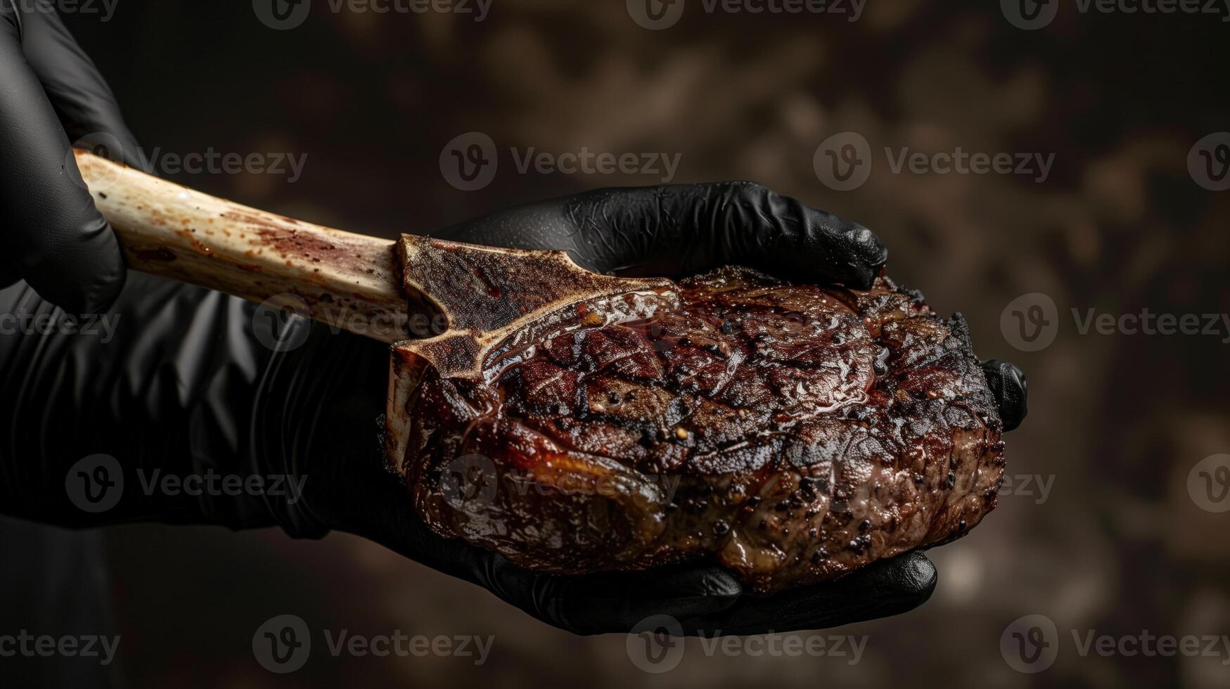 Chef's hand in a black glove holding a grilled tomahawk steak on a dark background for meat lovers photo