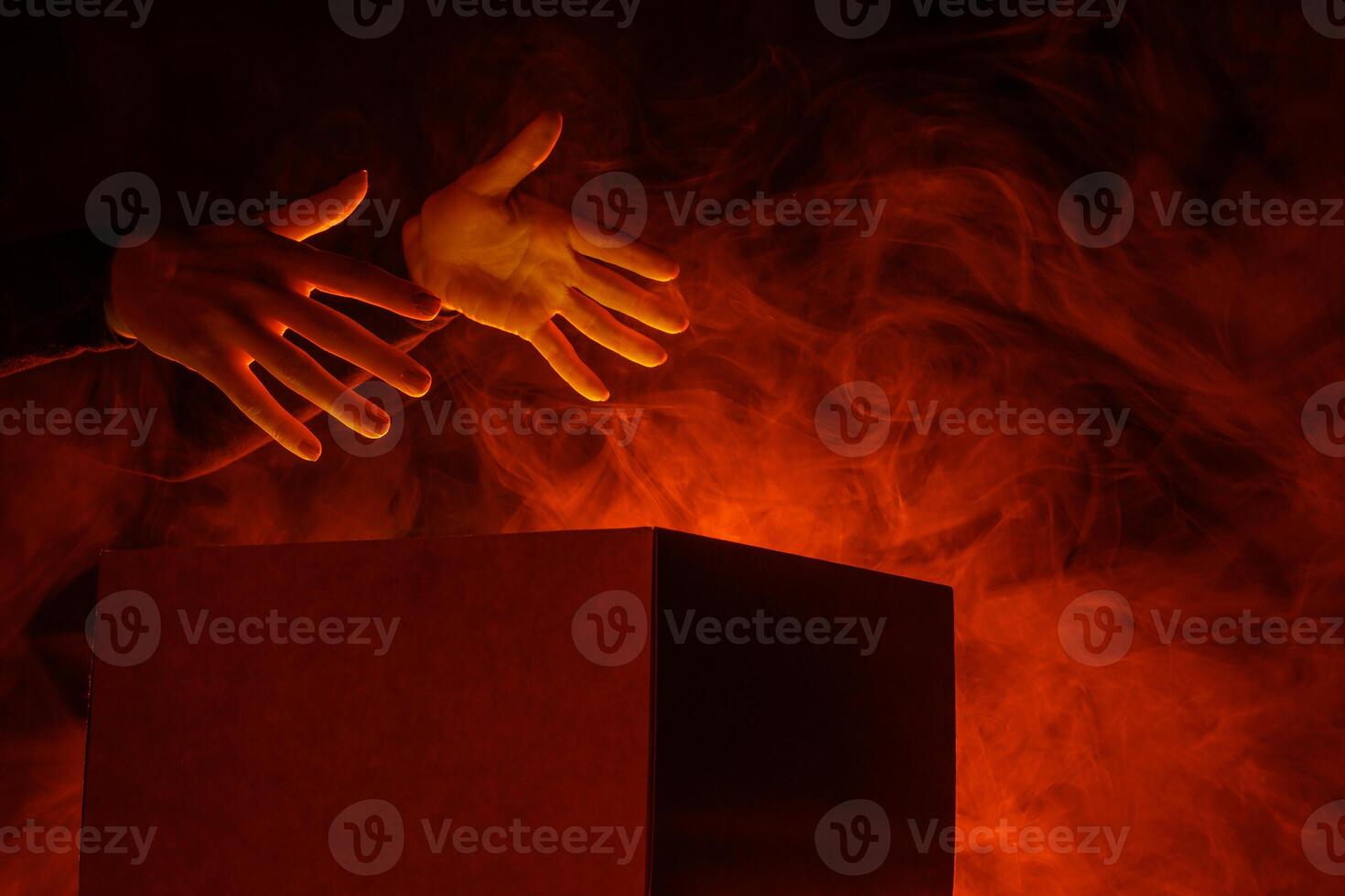 Man opens magic box with surprise on dark background, mystical box, surprise, halloween photo