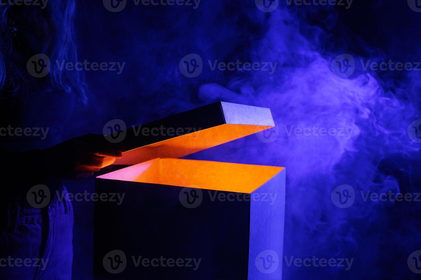 Man opens magic box with surprise on dark background, mystical box, surprise, halloween photo