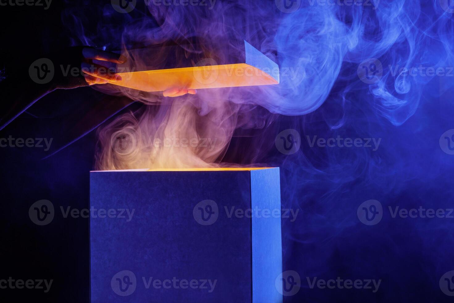 Man opens magic box with surprise on dark background, mystical box, surprise, halloween photo