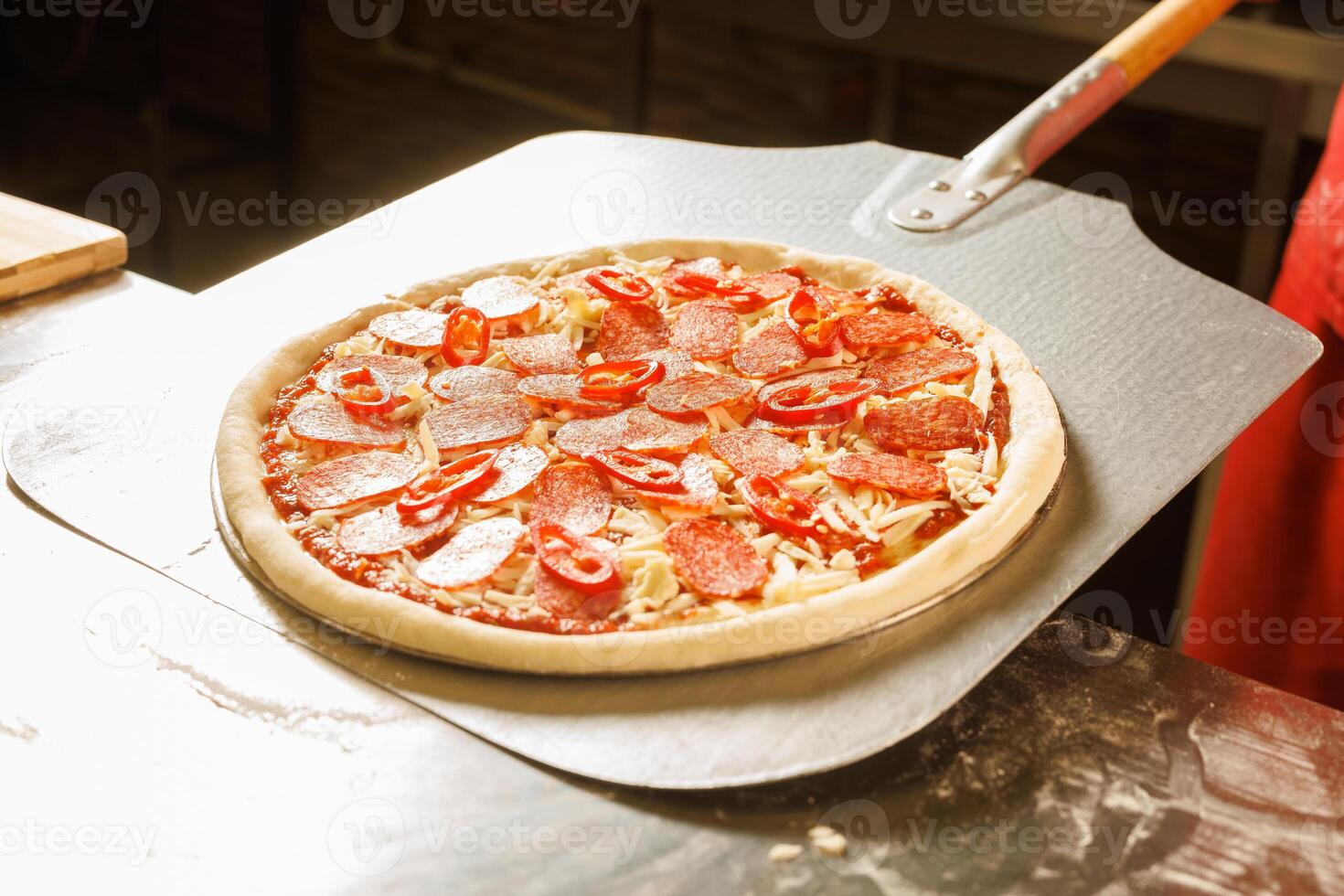 Chef preparing to bake a pizza photo
