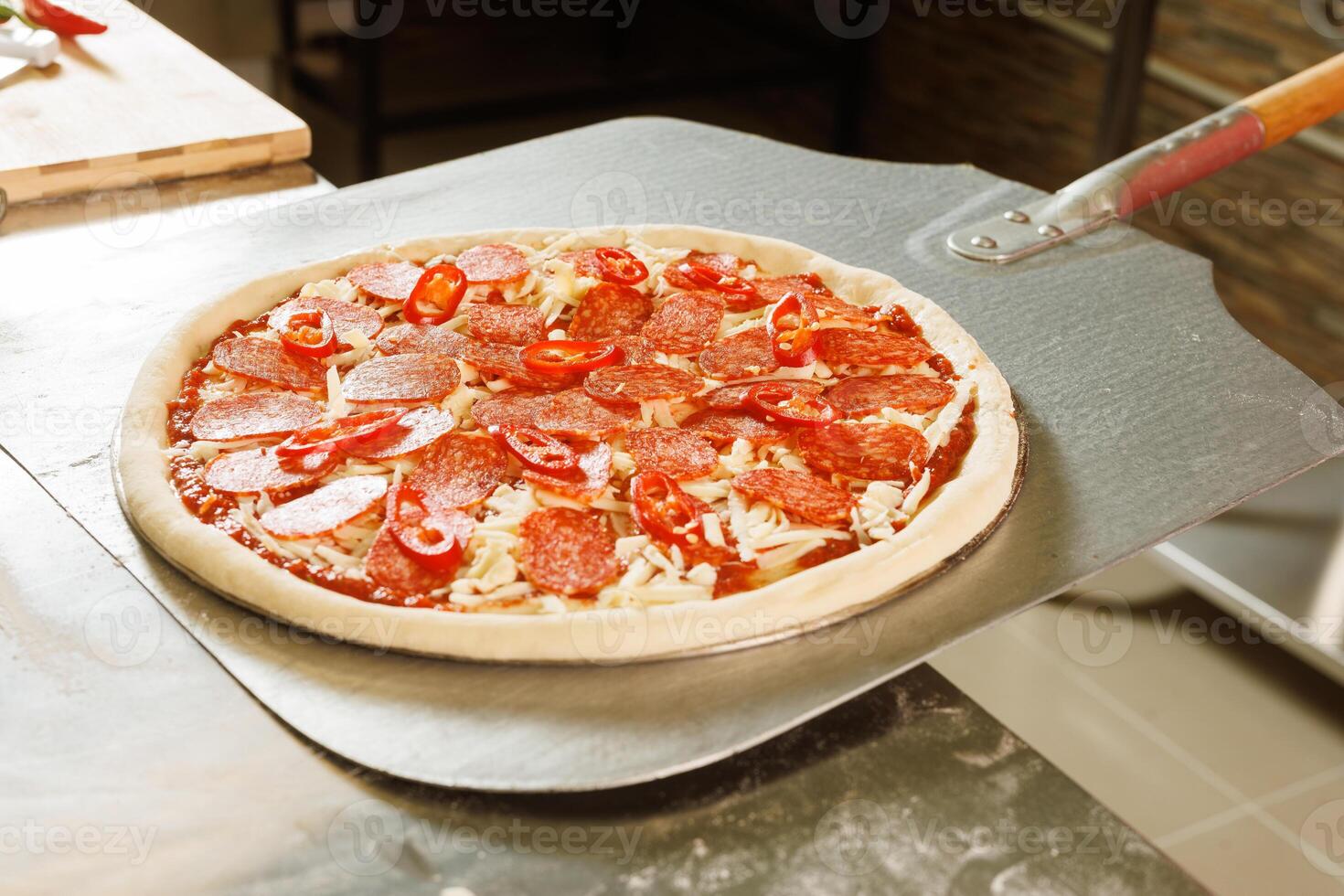 Chef preparing to bake a pizza photo