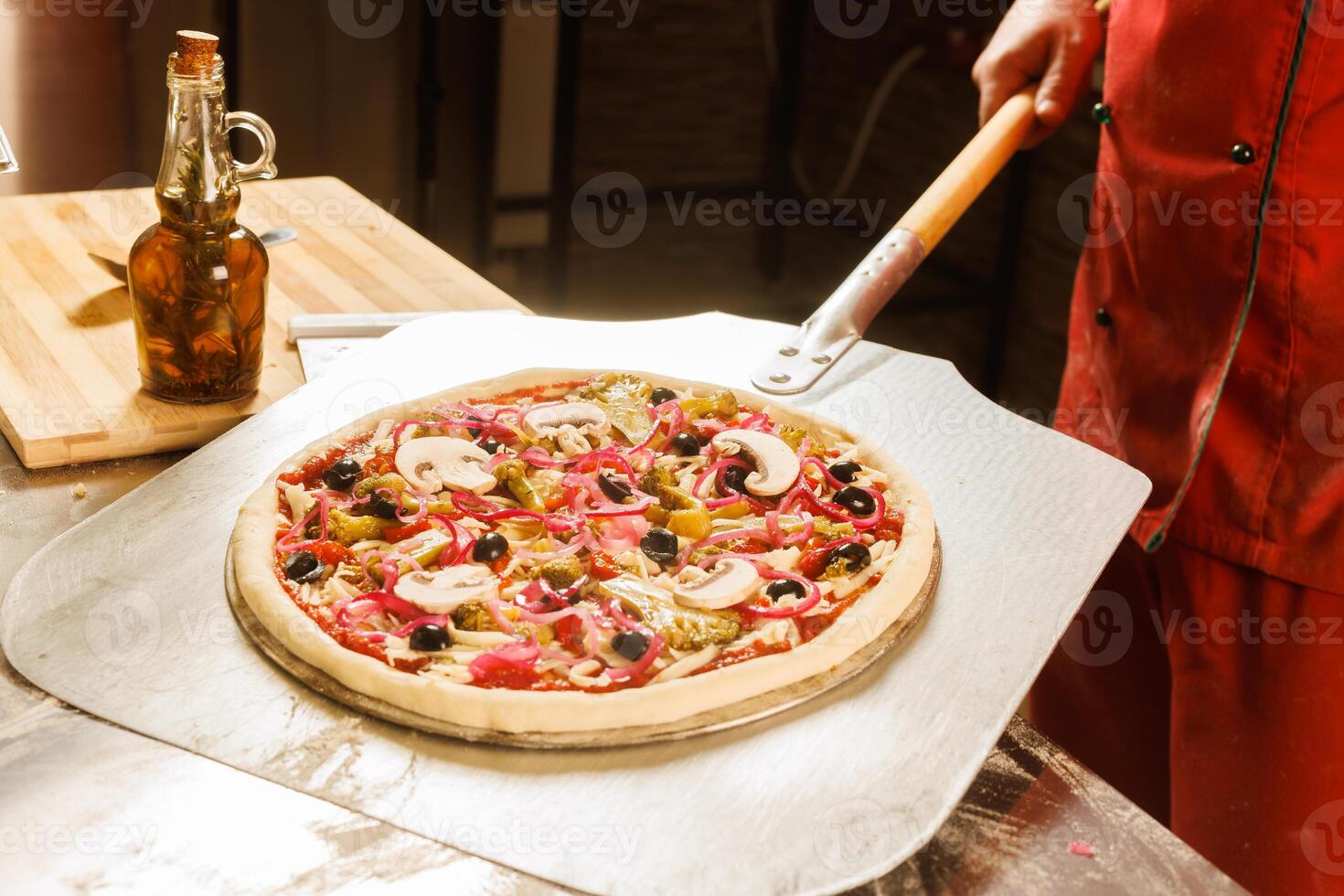 Chef preparing to bake a pizza photo