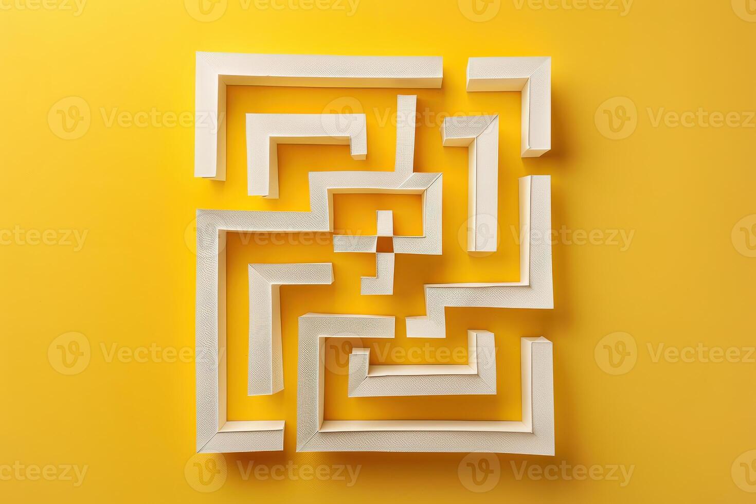 A white maze made out of paper on a yellow background photo
