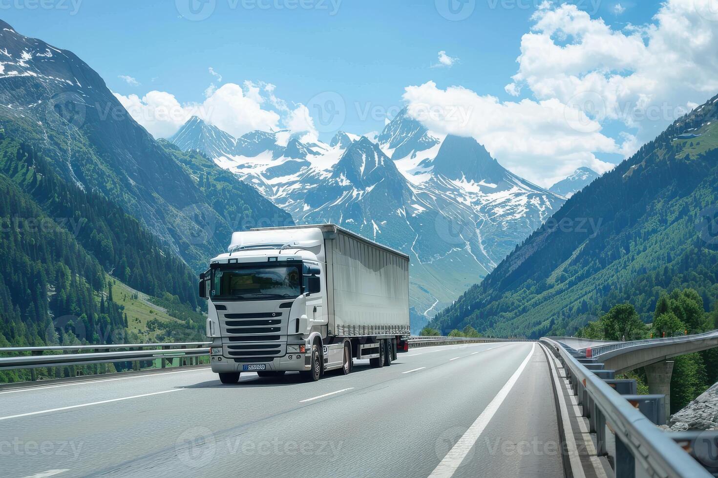 A truck driving on a highway in front of mountains photo