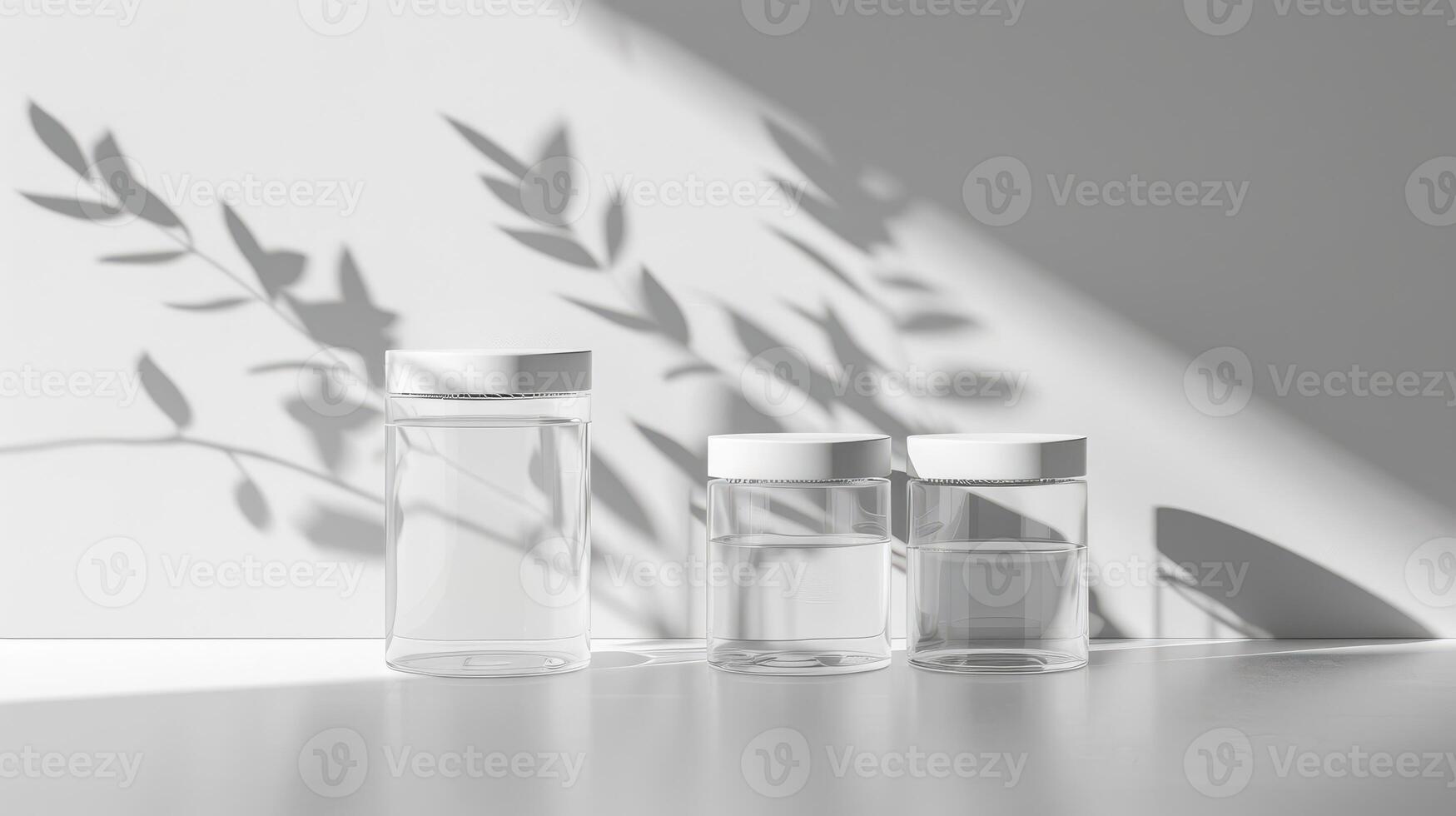 Three empty glass bottles with leaves on a white surface photo