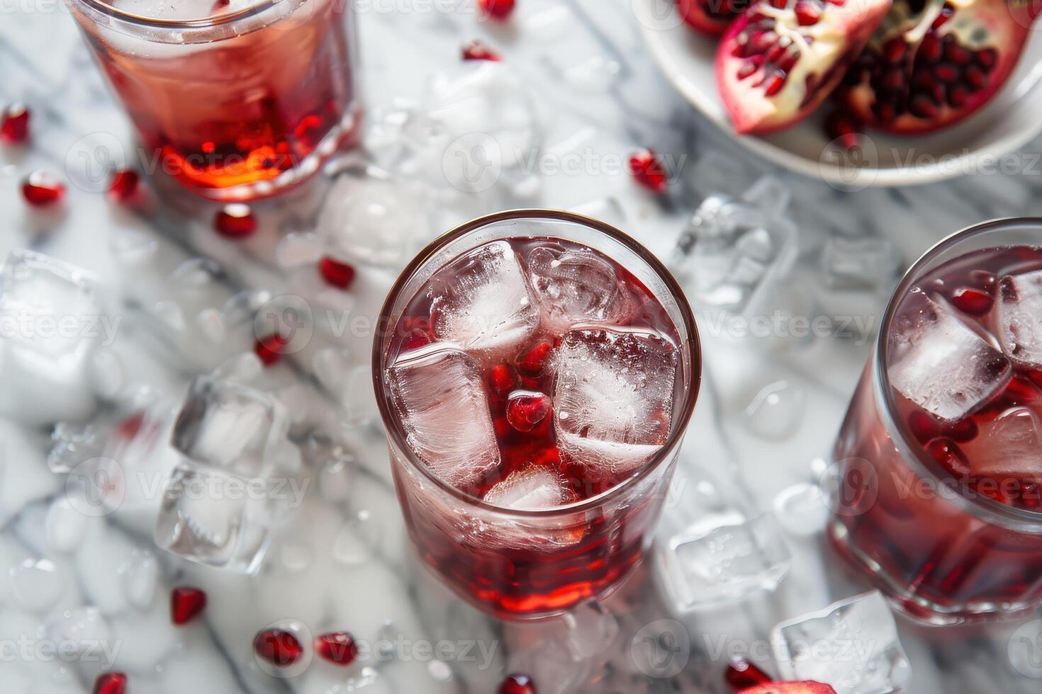 Three glasses of pomegranate juice with ice photo