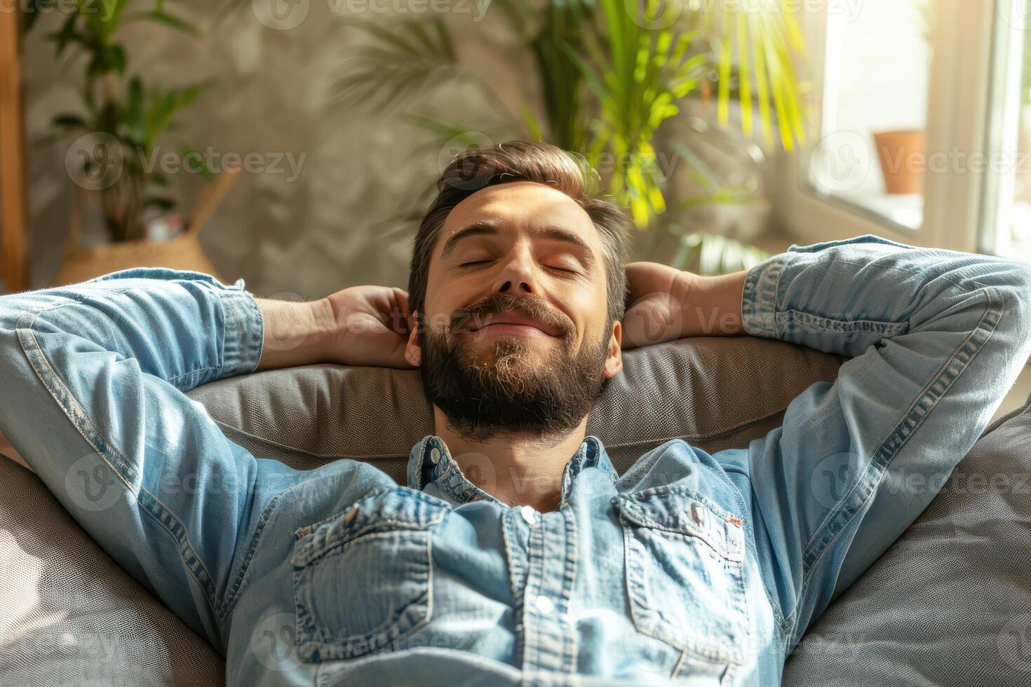 A man is relaxing on a couch photo