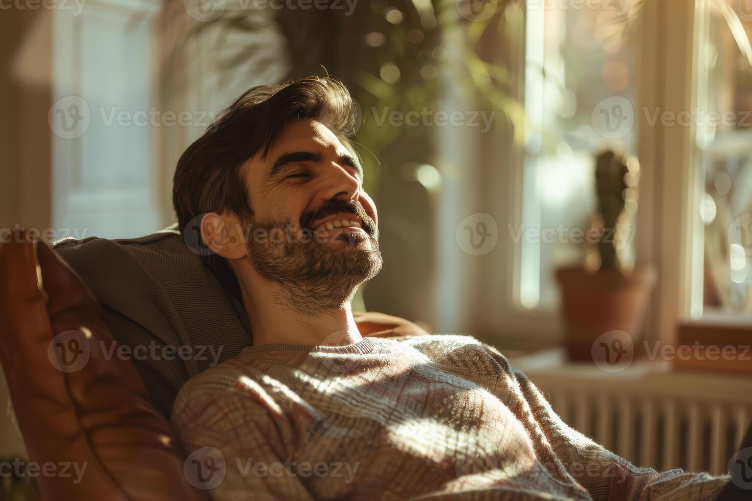 A man is smiling while sitting in a chair photo