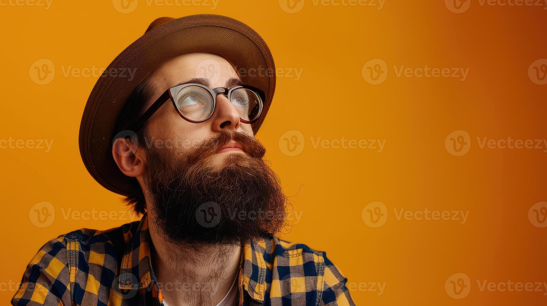 A man with a beard and glasses wearing a hat photo