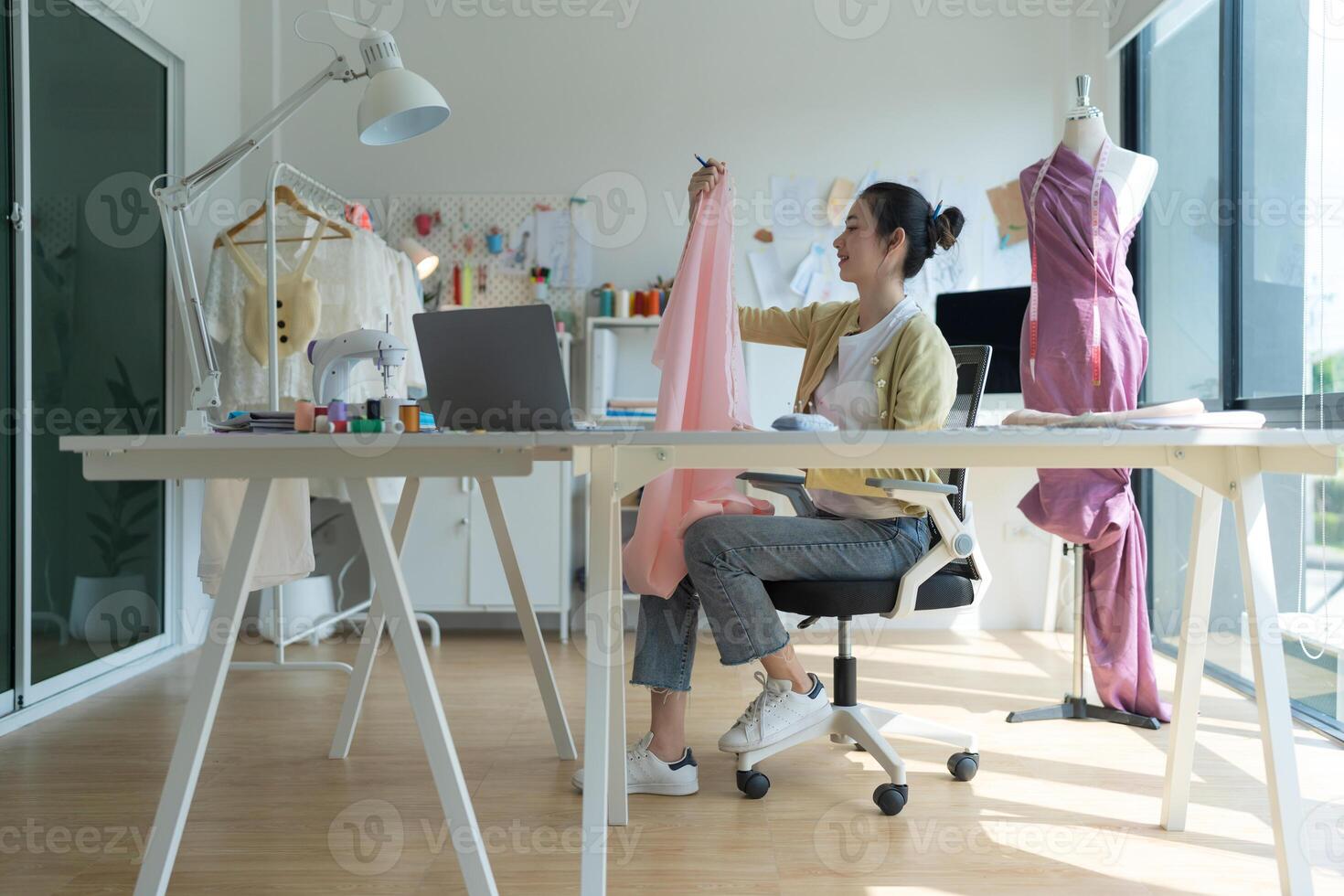 Asian fashion designer working on new clothes collection photo