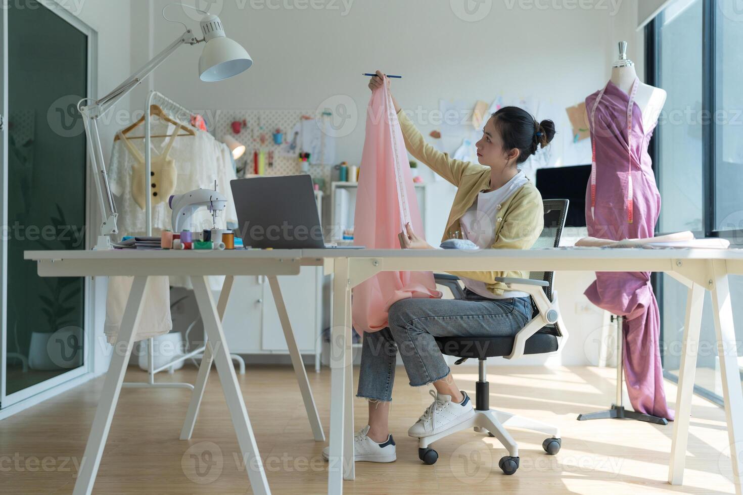 Asian fashion designer working on new clothes collection photo