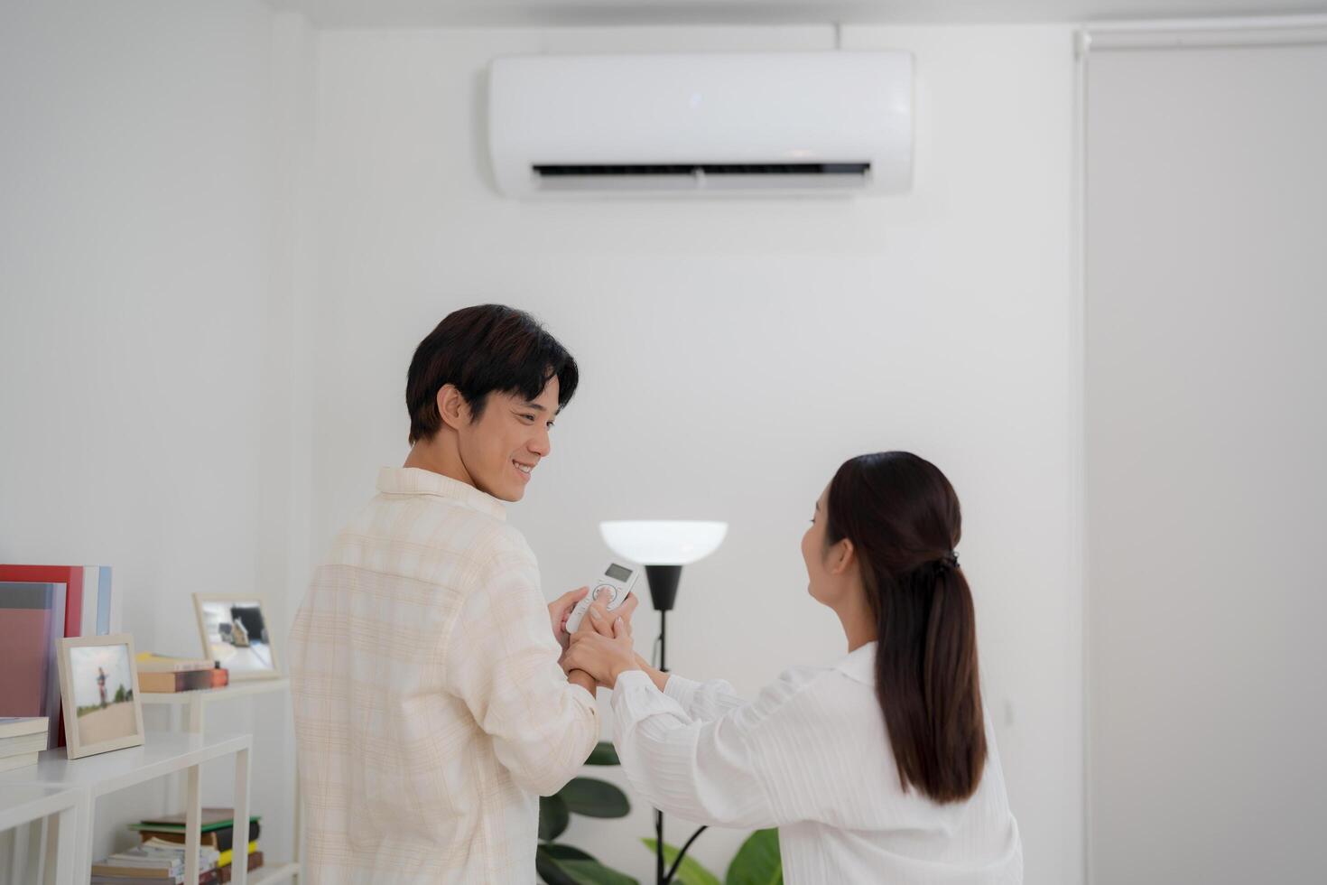Couple enjoying air conditioning at home photo