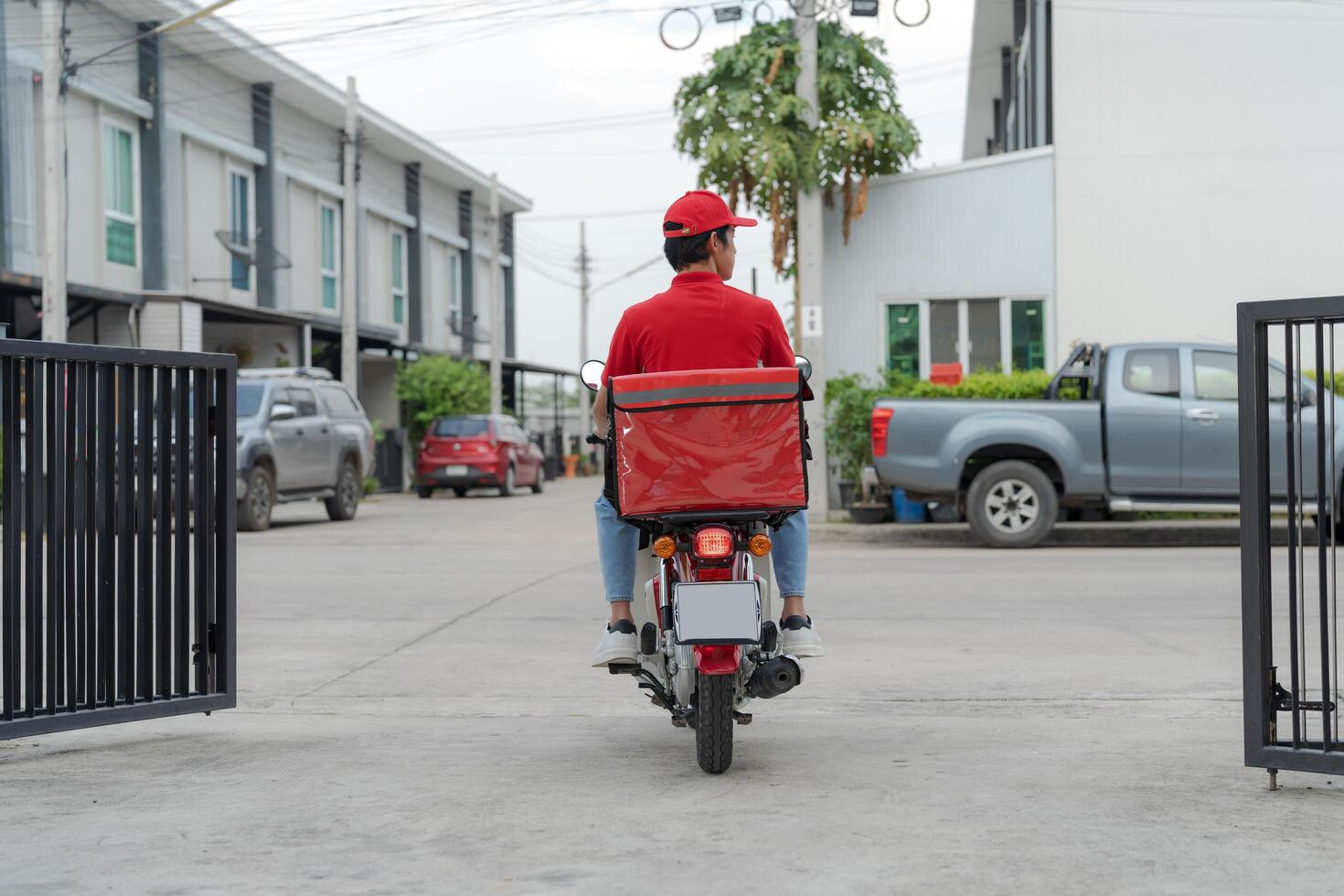 Delivery rider on motorbike in urban setting photo