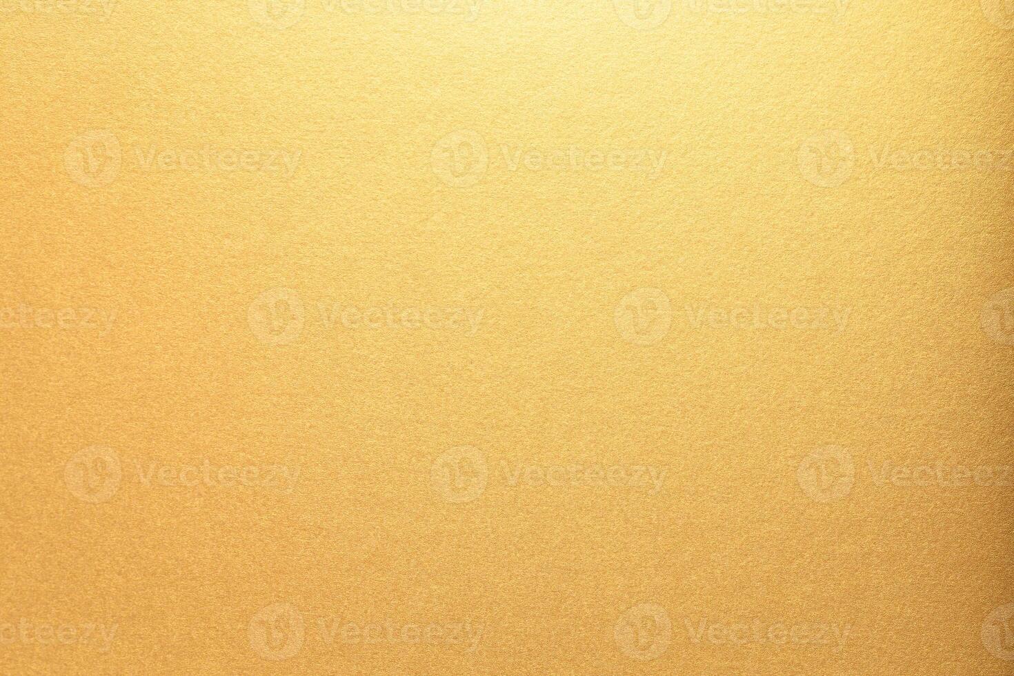 Gold paper with a smooth, glossy texture and bright, glowing gradient. The shining metallic surface photo
