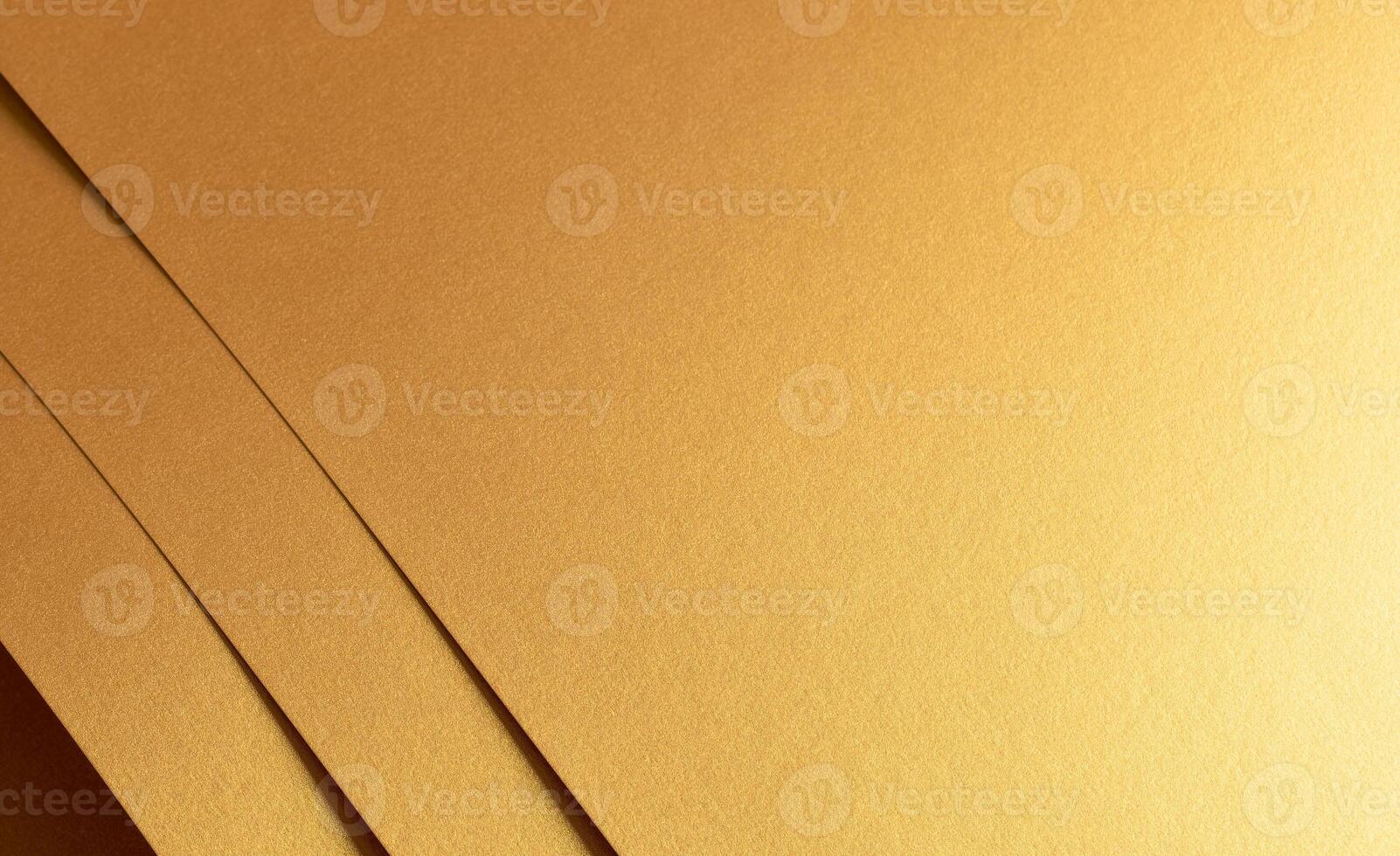 Golden metallic paper with a layered texture and warm brass and yellow tones. The minimalist, photo