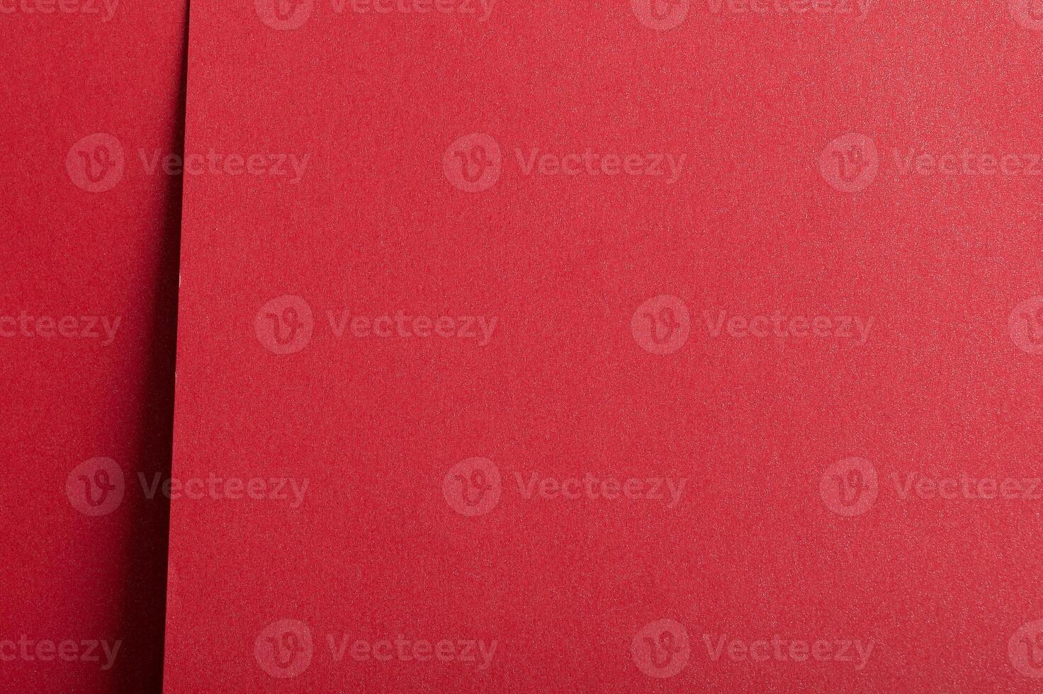 Paper with a rich texture and luxurious, scarlet red tone. The minimalist, monochrome surface photo