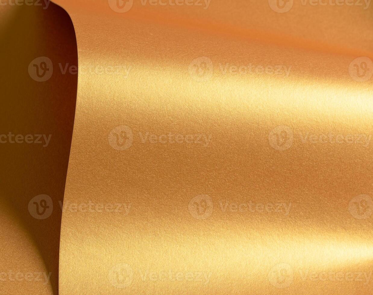 Golden paper with a metallic texture and wavy folds. The shiny, glowing surface features rich brass photo