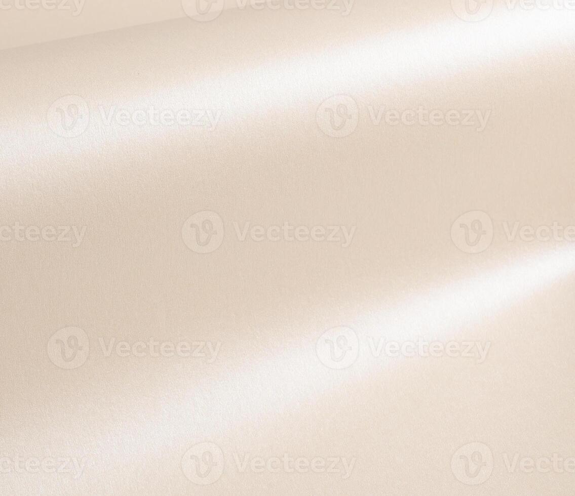 Beige paper with a smooth, glossy sheen and reflective folds. Elegant, minimal texture with a soft, photo