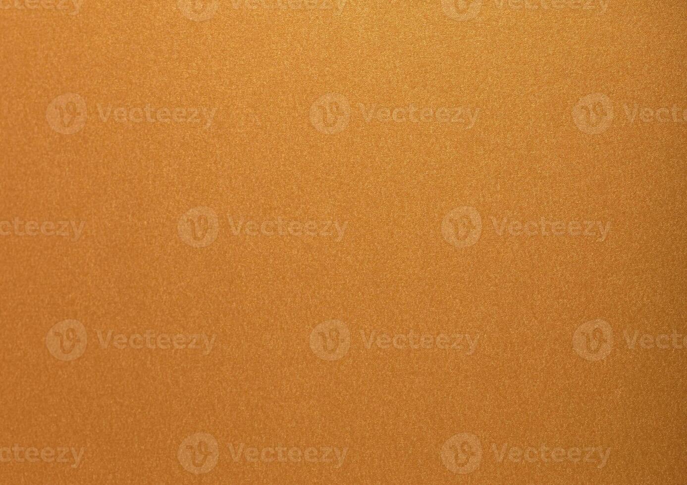 Gold paper with a glossy, metallic texture featuring soft, smooth surfaces in brass and bronze tones photo