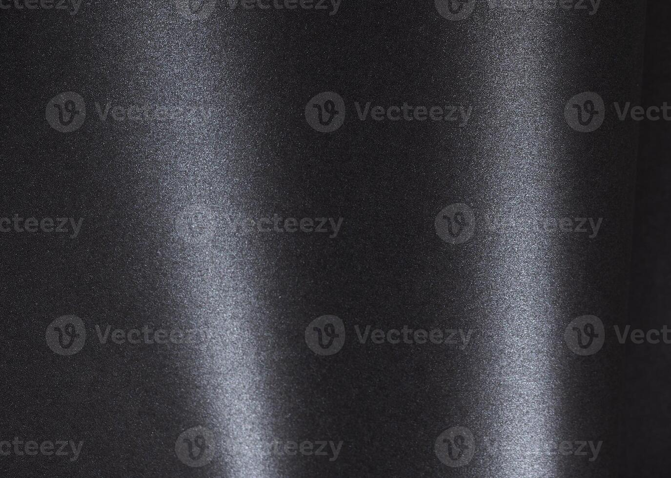 Black paper with a textured surface and minimalist monochrome background. Featuring dark, elegant photo