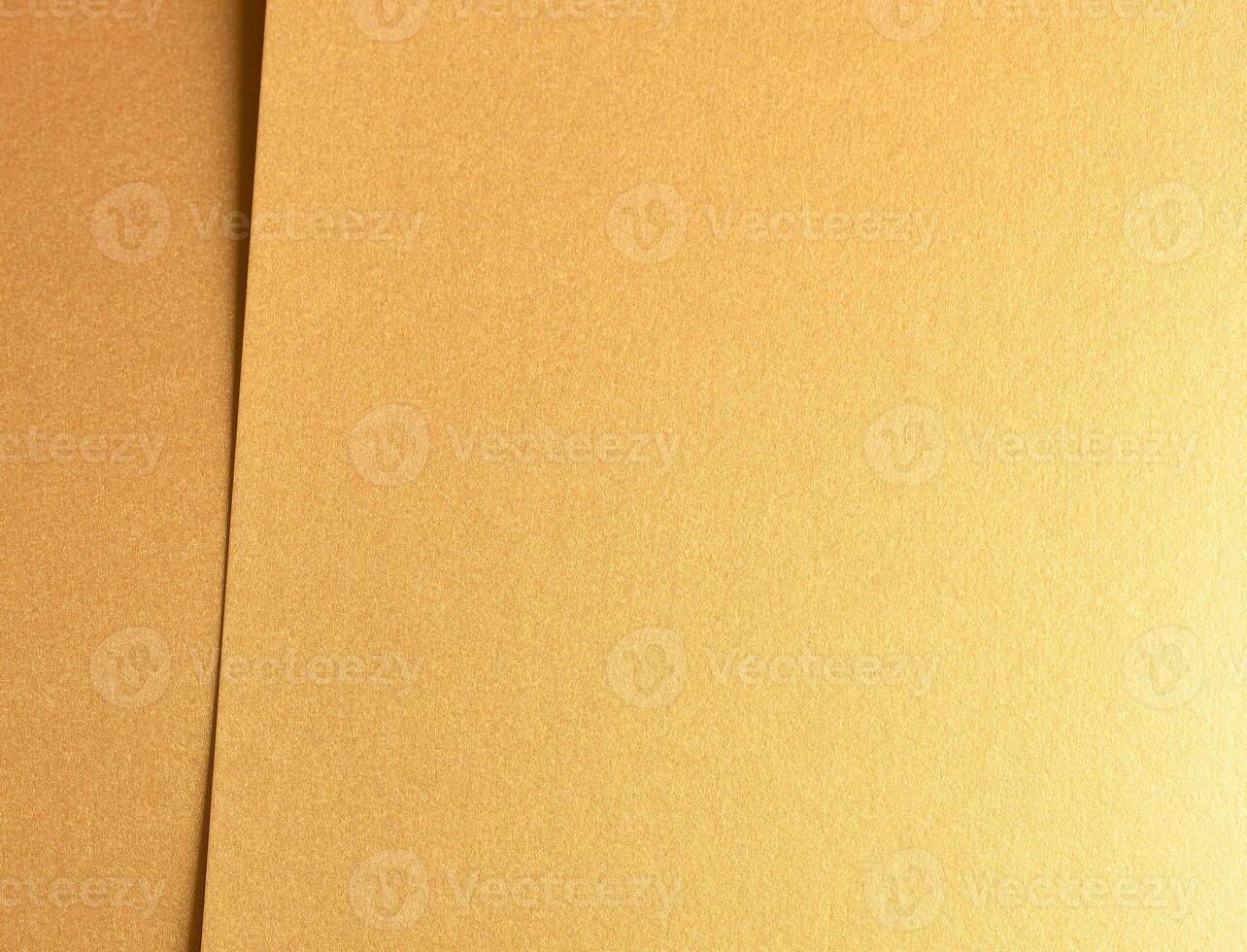 Golden metallic paper with a rich, glossy texture and shiny surface. The elegant, layered design photo