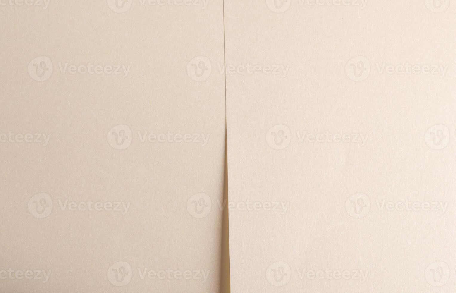 Beige paper texture with smooth folds and neutral tones. Layered lines and soft shadows create a photo