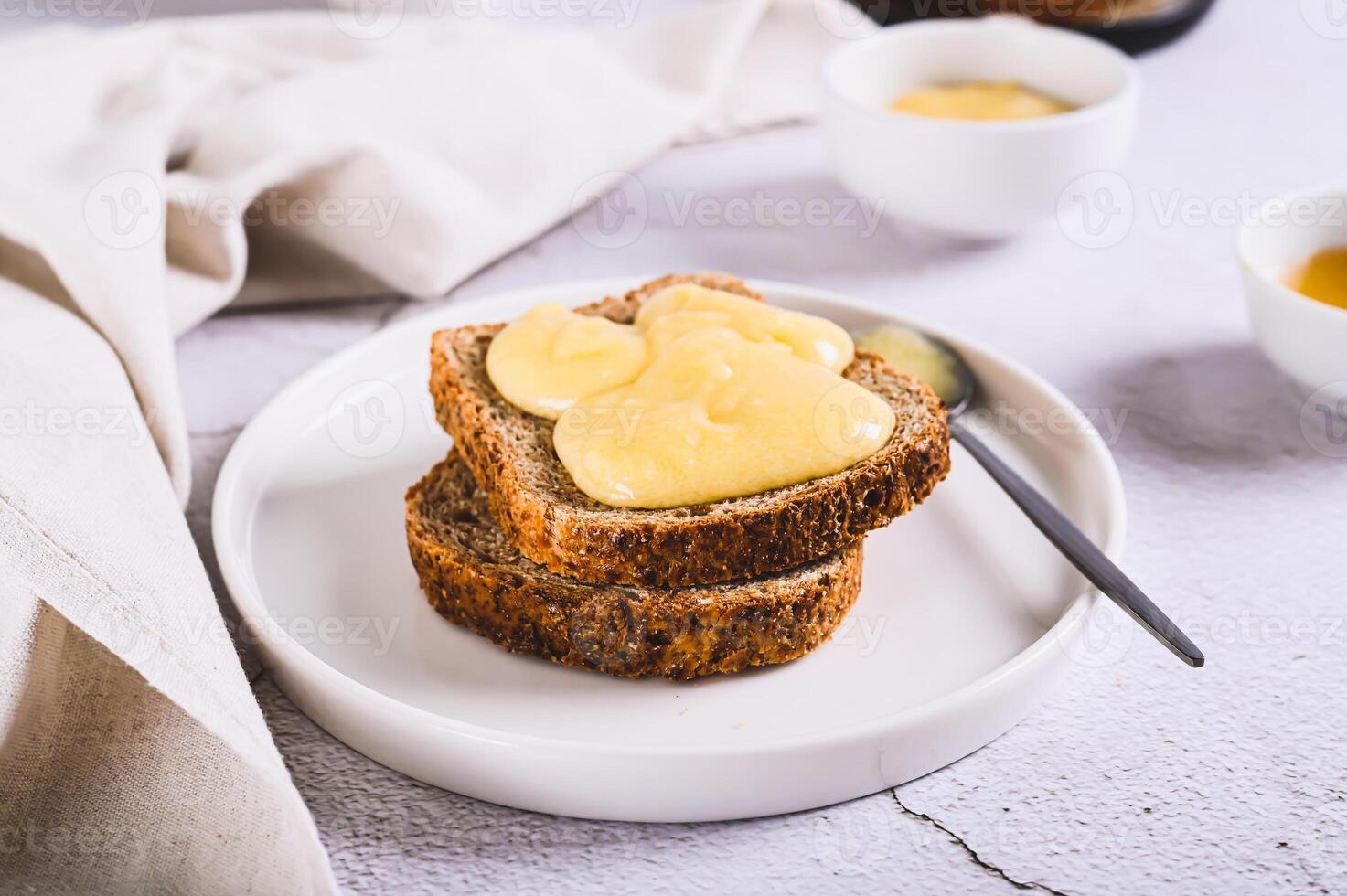 Morning sandwiches on grain bread with honey butter on a plate on the table photo