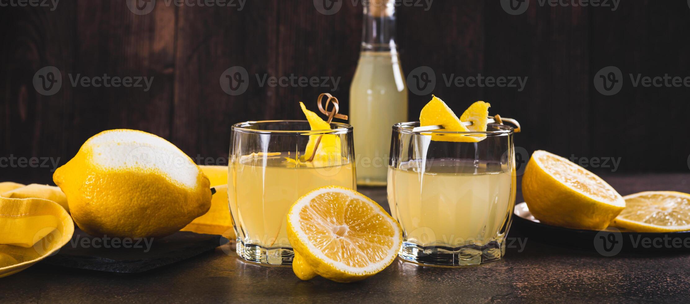 Traditional homemade limoncello in glasses on the table web banner photo