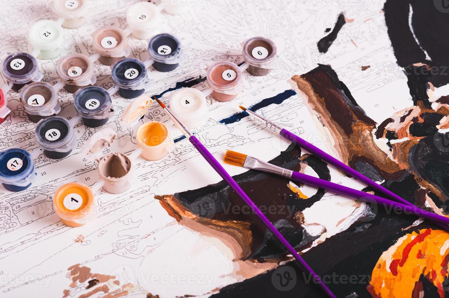 Set of multi-colored acrylic paints, brushes and canvas for painting by numbers photo