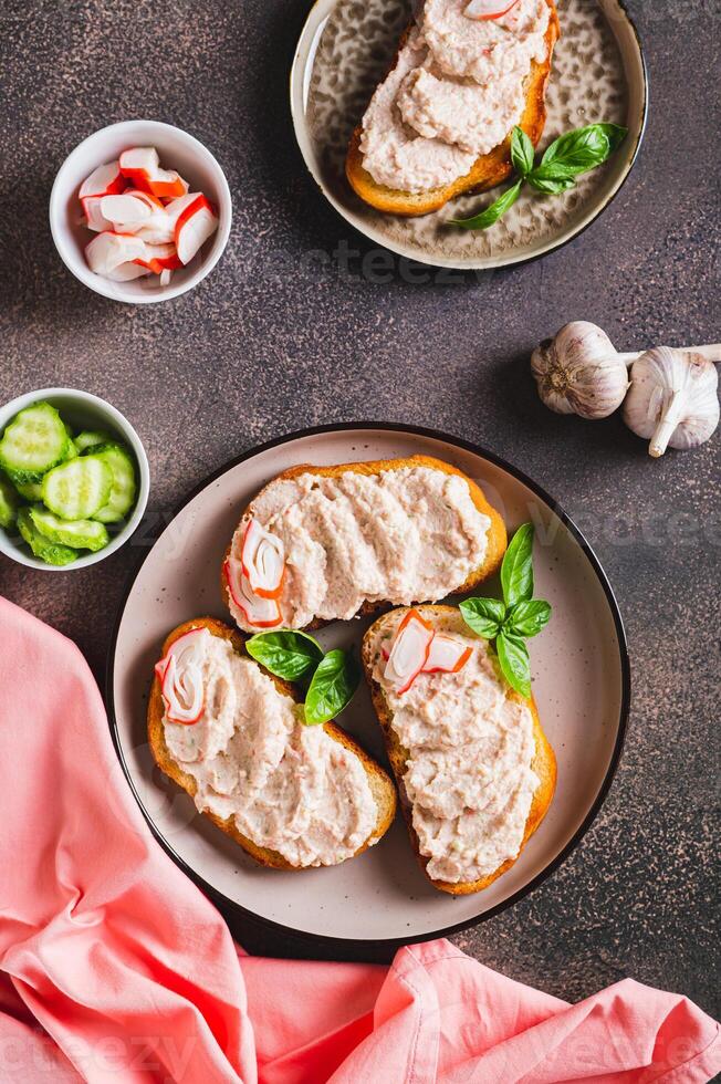 Delicious sandwiches with crab meat and cucumber pate on a plate top and vertical view photo