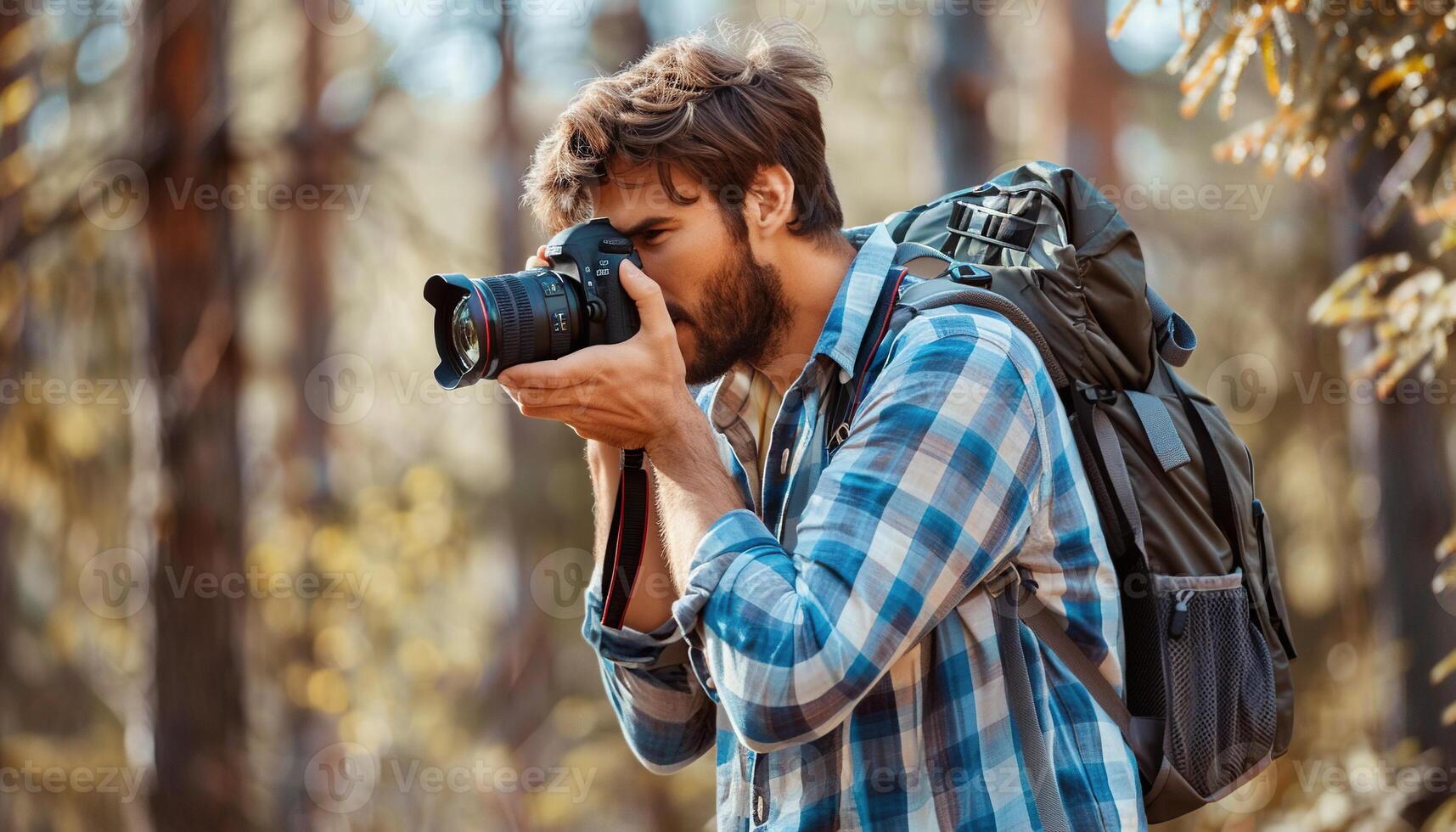 Young hipster photographer taking photos in nature with a professional camera. Copy space, pictures, microstock photography contributor, student