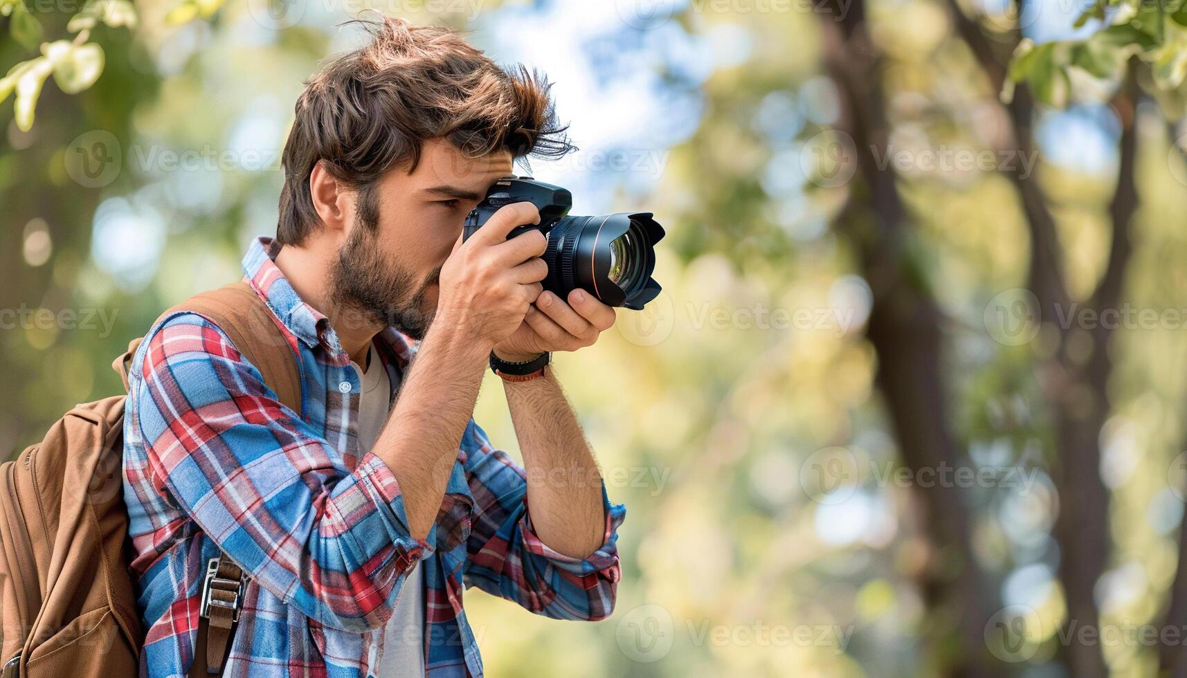 Young hipster photographer taking photos in nature with a professional camera. Copy space, pictures, microstock photography contributor, student