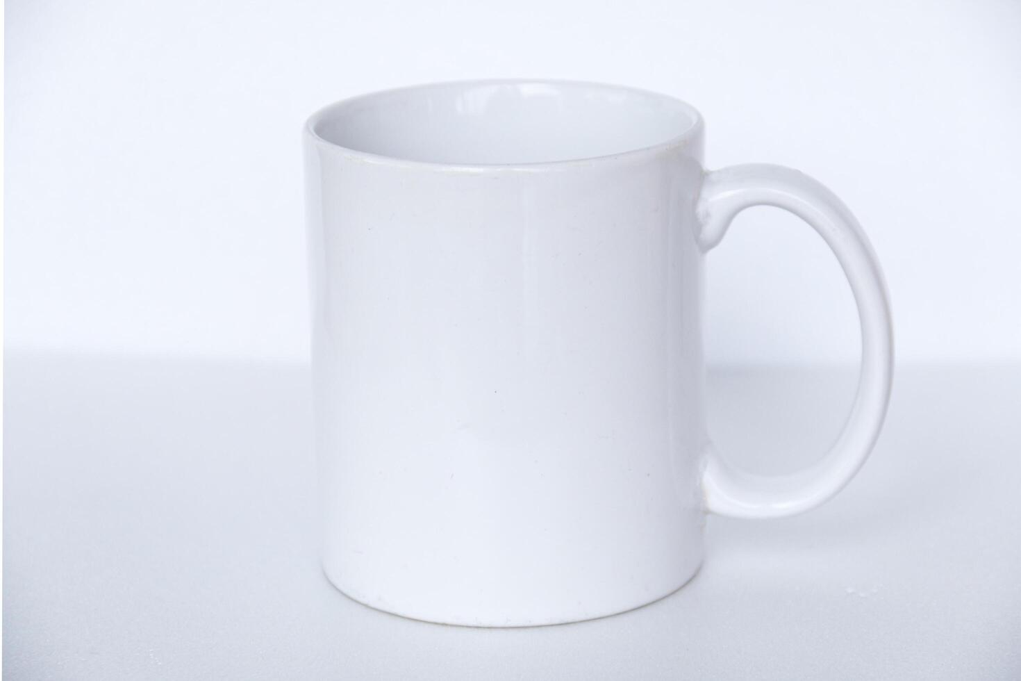 Elegant white ceramic mug isolated on a blank background, suitable for product marketing, mockups, and graphic design photo