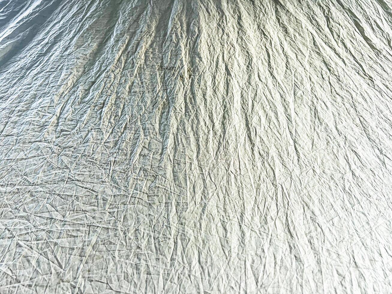 Detailed view of crumpled fabric texture, perfect for showcasing textile design, material backgrounds, and abstract patterns photo