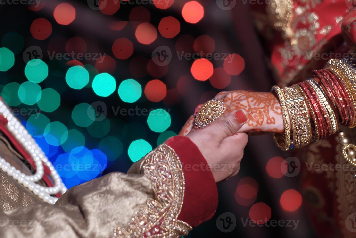 The Traditional Wedding Ritual Hands in Unity with a Colorful and Festive Background photo