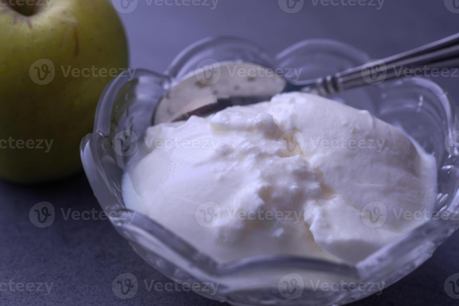 Delicious Fresh Yogurt Accompanied by Artistically Arranged Green Apple Slices on a Gray Background photo