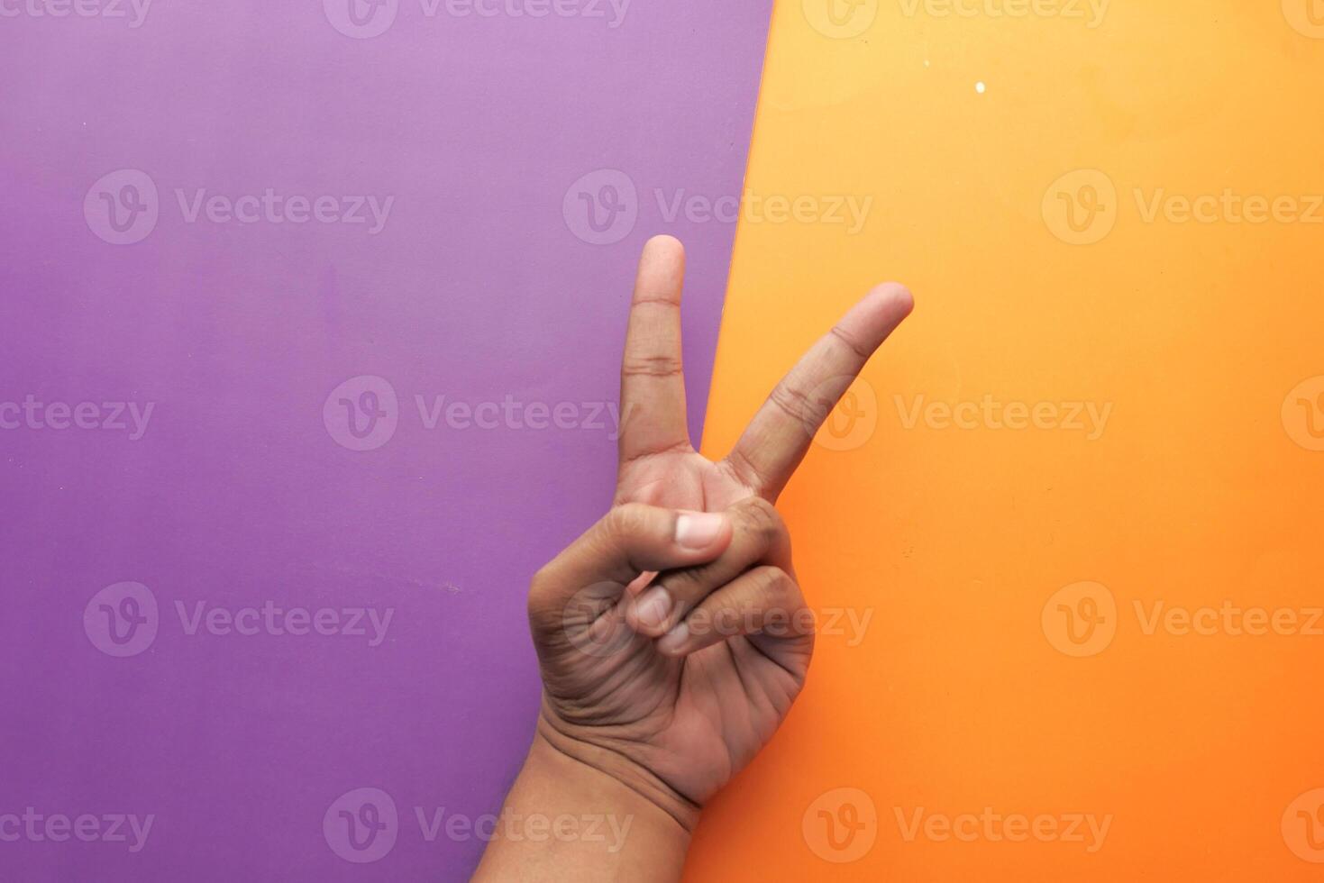 A Peace Sign Gesture Set Against a Vibrant and Colorful Background for Visual Impact photo