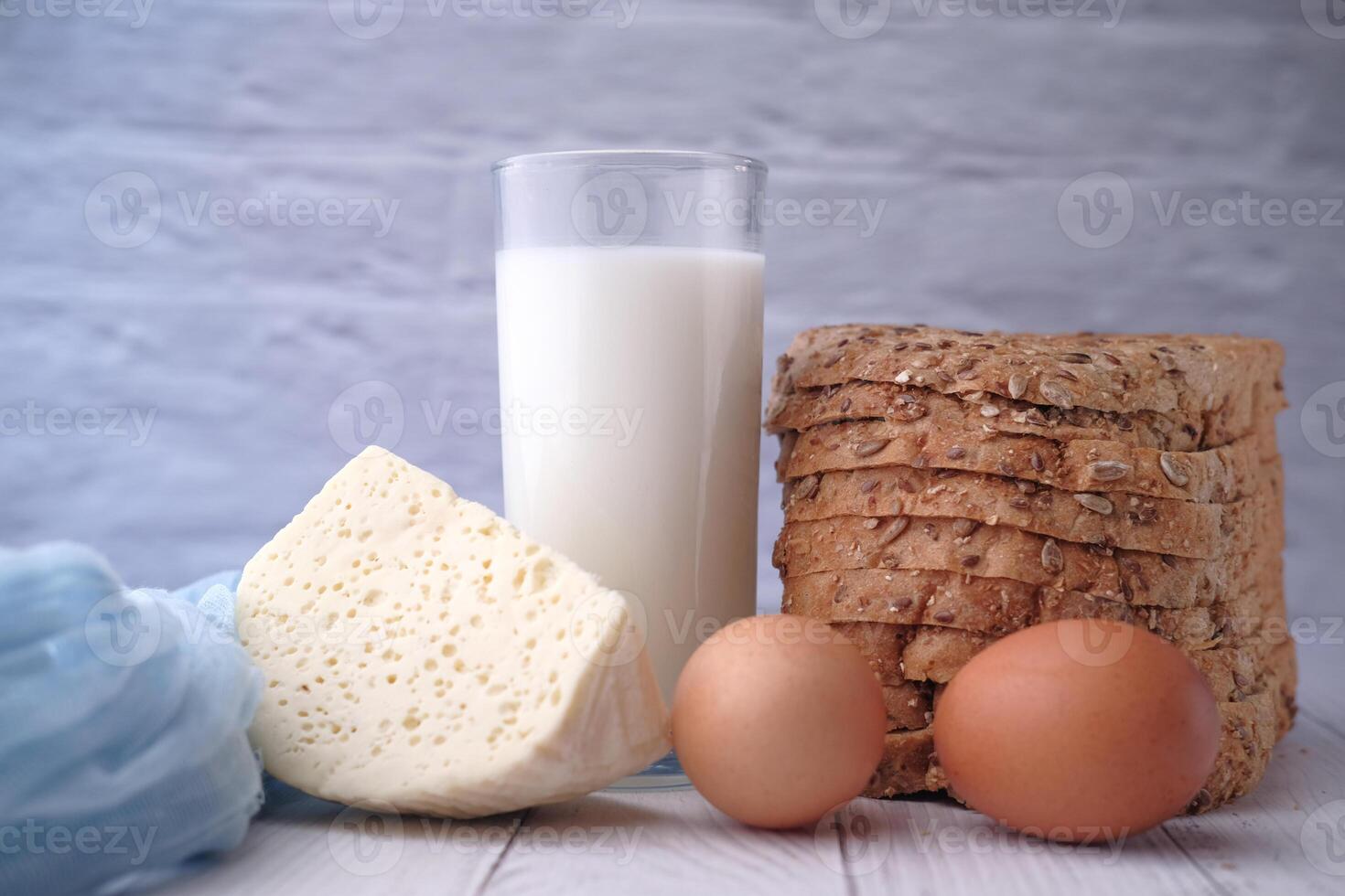 Fresh Ingredients An Array of Milk, Eggs, Cheese, and Artisan Bread Composition photo