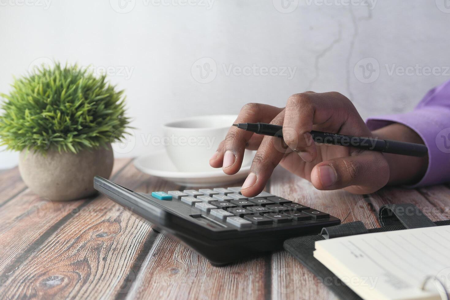 Business calculation conducted while enjoying coffee at a wooden table workspace photo