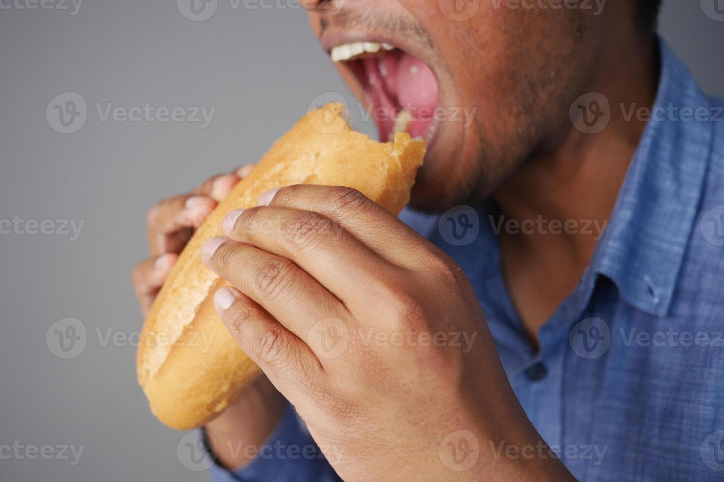 A CloseUp Image of a Person Enjoying and Eating a Delicious Sandwich with Delightful Ingredients photo