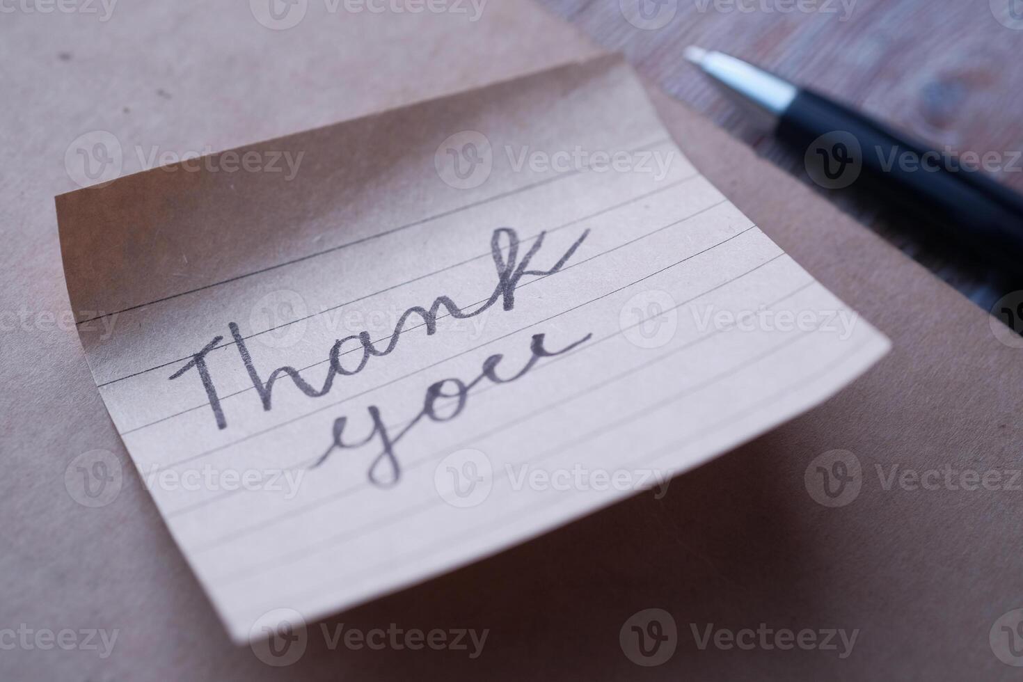 A beautifully crafted handwritten thank you note displayed on a stylish background photo