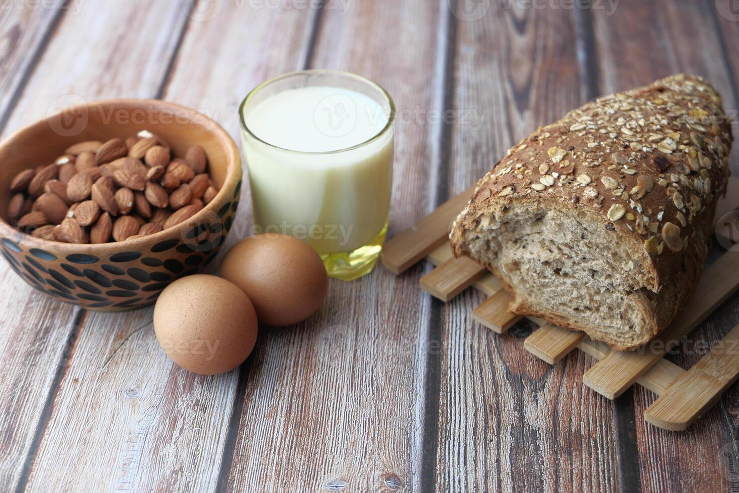 Essential Ingredients for a Nutritious Breakfast Eggs, Milk, Almonds, and Whole Grain Bread photo