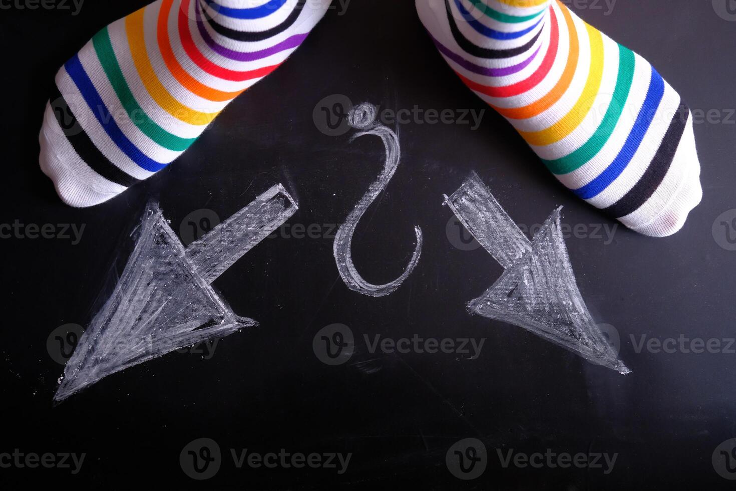 Vibrant and Colorful Striped Socks Featuring Directional Arrows and an Intriguing Question Mark photo