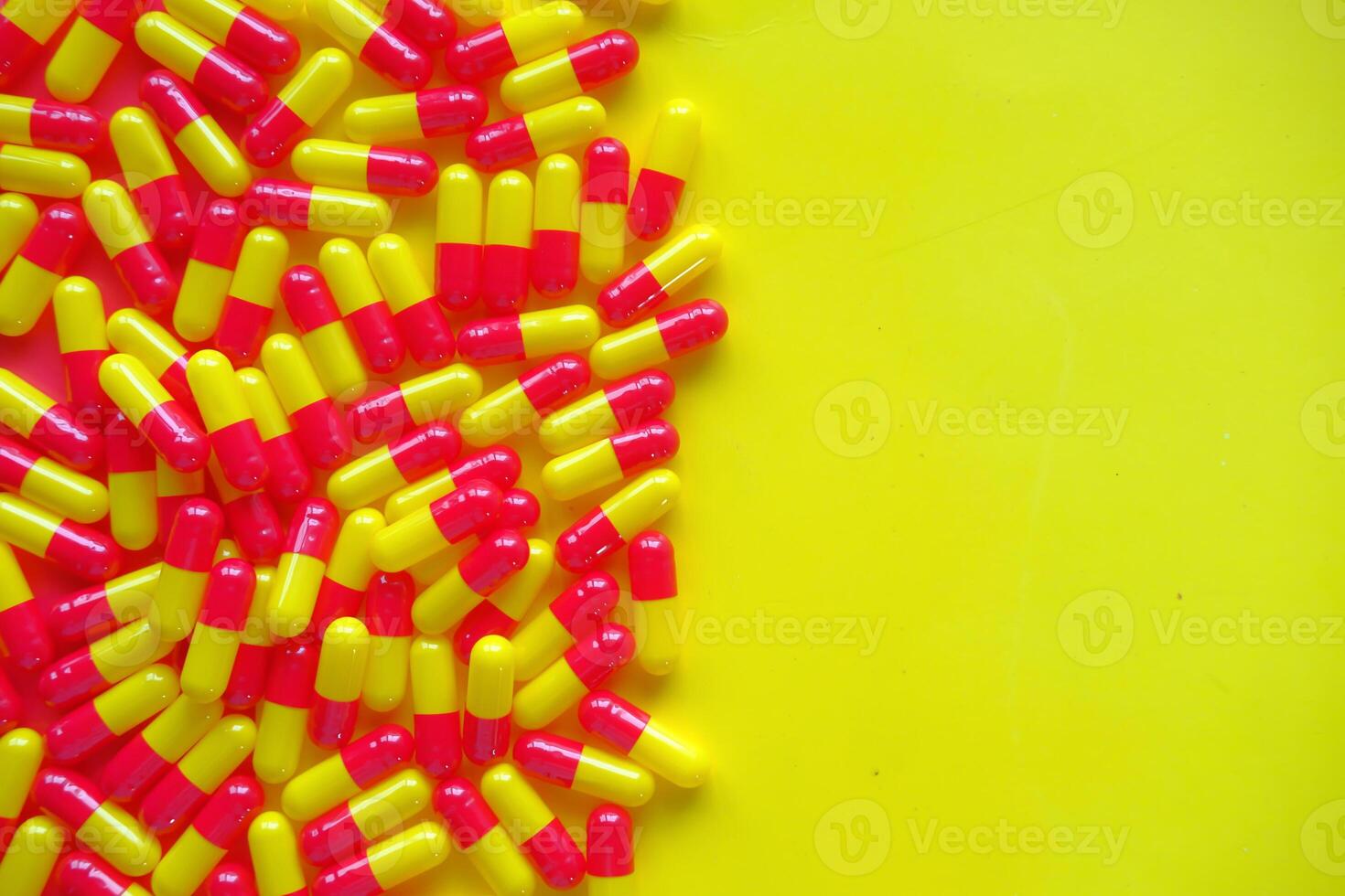 Vibrantly Colored Yellow and Pink Capsules Displayed on a Bright, EyeCatching Background photo